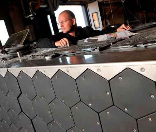 Project manager Peder Sjorlund surveys electronically heated tiles that act as independently   addressable to generate custom IR signatures.  (Photo courtesy of BAE Systems.)