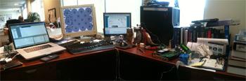 The laptops on the desk of Mike Burr, Jacksonville, Fla. are laid out in a panorama.