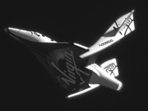The VSS Enterprise, the first of five SpaceShip Two commercial spacecraft, all with all-carbon-composite structures, returns to Earth in its first feather, or unpowered, flight on May 4, 2011.   (Source: Clay Center Observatory)