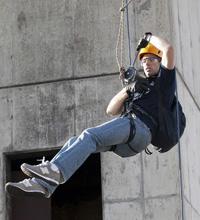 Student Dave Monk demonstrates the winch device.   (Source: BYU)