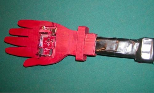 The circuit board and LEDs are placed on a wooden hand that Rich cut out using his own hand as a template. 