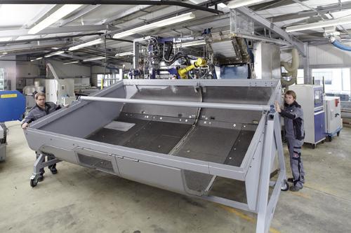 A prototype diesel train engine housing made of a new polyurethane-based glass fiber sandwich material saves 35 percent weight and 30 percent cost over its steel and aluminum counterpart.   (Source: Bayer MaterialScience)