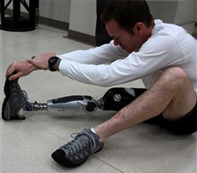 Outfitted with one of the Army's newly designed autoadaptive and flexible prosthetic limbs, Army Staff Sgt. Billy Costello, who lost his leg in combat, stretches and flexes his foot.   (Source: Department of Defense) 