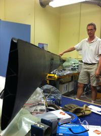 An unusual wing, made in a single piece from carbon fiber composite, has been built for an unmanned aircraft designed for high-altitude perpetual flight. Shown here with mechanical engineer Joachim Grenestedt, the 6.5m (21.3ft) wing has no fasteners or adhesive joints.
  (Source: Lehigh University)
