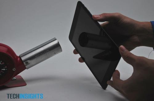 Using the heat gun to soften the adhesive around the touchscreen.