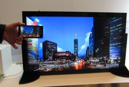 With the Miracast peer-to-peer wireless screencast standard created by the WiFi Alliance, consumers can wirelessly display what they see on their handhelds on a big-screen TV. Shown above is a Miracast demo at MediaTek's private suite. Many, including Broadcom's CTO Henry Samueli, wonder why consumers would want to battle with a complex user interface for smart TVs if you can easily select what you want to see on a handheld and wirelessly display it on a large-screen TV in a living room.