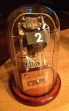 David Christianson's inline clock has an electromechanical incandescent display based on an arrayof tiny projectors sharing a ground glass rear projection plane.
