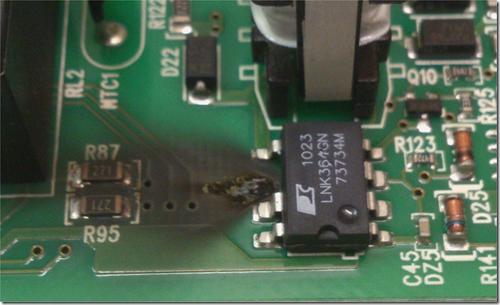 Here's the burned spot next to the broken LNK364 IC.