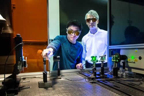  Oak Ridge National Laboratory's Jian Chen (left) and Adrian Sabau work with a laser to prepare the surfaces of carbon fiber composites and aluminum before joining. This new surface preparation technique creates superior bonds that can absorb 200% more energy than bonds made with conventional preparation techniques. (Source: Oak Ridge National Laboratory) 