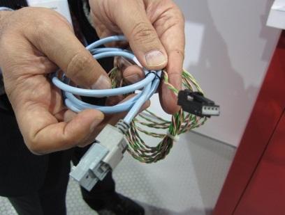 The MOST auto connectivity spec is on the way out as new unshielded single twisted-pair cable arrives for automotive Ethernet (compare it with regular Ethernet cable on the left). This means auto makers can leverage the ubiquitous Ethernet standard while reducing the connectivity cost and cabling weight.