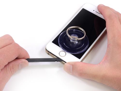 iFixit's suction cup and spudger (shown) enabled the teamto open the iPhone 5s carefully.(Source: iFixit)