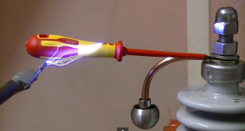 A screwdriver handle failing to stop a 100,000-volt arc.
Click here for the video.
