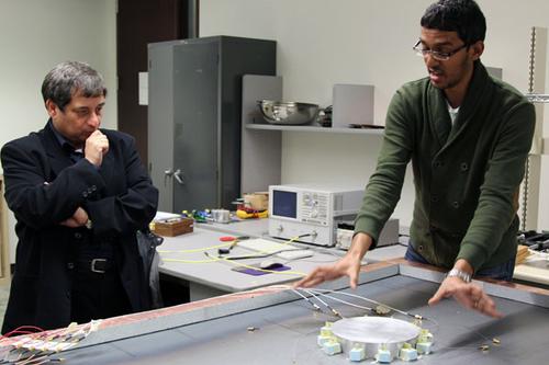 Professor George Eleftheriades (left) and doctoral candidate Michael Selvanayagam showing their new approach to invisibility cloaking. (Credit: Marit Mitchell) SOURCE: University of Toronto