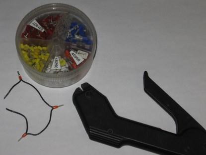 Figure 10. A 'ferruled' wire, a selection of ferrules, and a low-end crimping tool. As you can see, ferrules also make it easy to daisy chain wire by twisting the ends together and crimping. (Click here to see a larger image.)