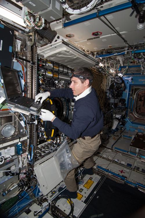 NASA astronaut Mike Hopkins, Expedition 38 flight engineer, performs in-flight maintenance on combustion research hardware in the Destiny laboratory of the International Space Station in this image taken on Dec. 30, 2013. Hopkins replaced a multi-user droplet combustion apparatus (MDCA) fuel reservoir inside the combustion integrated rack (CIR). The CIR includes an optics bench, combustion chamber, fuel and oxidizer control, and five different cameras for performing combustion experiments in microgravity. Click here for a larger image.
(Source: NASA)