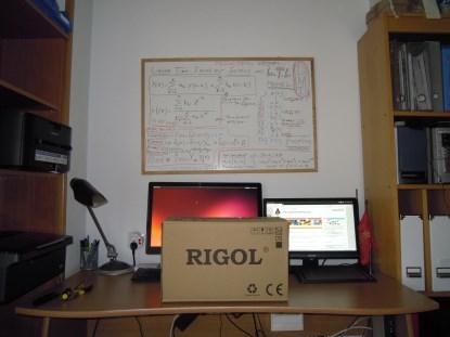 The newly arrived, boxed Rigol DS1052E oscilloscope sitting on my desktop.