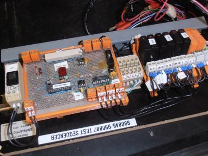 Figure 1. Comparators and a simple PLD sequence generator with hexadecimal readout of failure codes, hand-wired on protoboard, form the heart of this test equipment.