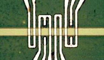 A picture of spin wave devices showing magneto-electric cells used for voltage-controlled spin wave generation in the spin wave bus material (yellow stripe). The yellow stripe is about four micrometers in diameter.(Source: UCLA Henry Samueli School of Engineering and Applied Science)