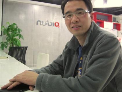 Nubia CEO with his hand covering its yet-to-be-announced Nubia X6. (He showed us the live demo with it, but he didn't want us to photograph it before the official launch.) (Source: EE Times/Junko Yoshida)