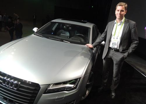 Andreas Reich next to the prototype Audi self-driving car on the San Jose stage at GTC 2014. (Source: EE Times)