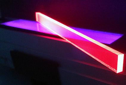 Normally transparent quantum-dot-impregnated window pane material luminescences under ultraviolet illumination. (Source: Los Alamos National Laboratory)