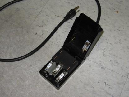 The open Safebloc showing the connection clips and the connection bars in the cover, as well as the fuse. The new model appears to have the clip color coded and the cover in red. (Click here for a larger image.)