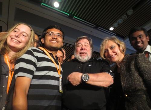 Steve Wozniak (center) shows his nixie tube watch to an EE Times reporter as he was mobbed on stage after his appearance by techno-fans wanting a picture with the Silicon Valley icon.