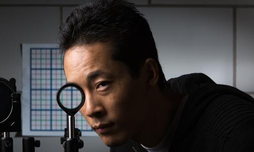 University of Rochester researcher cloak using a special lens--the first invisibility cloak to work in the visible spectrum, according to the researchers.
(Source: Adam Fenster, University of Rochester)