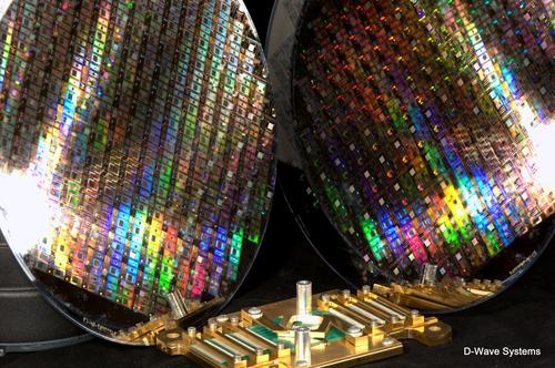 D-Wave gets about 100 quantum computer chips per wafer (two shown here) which is mounts on a super-cooled mounting (middle below).
(Source: D-Wave)