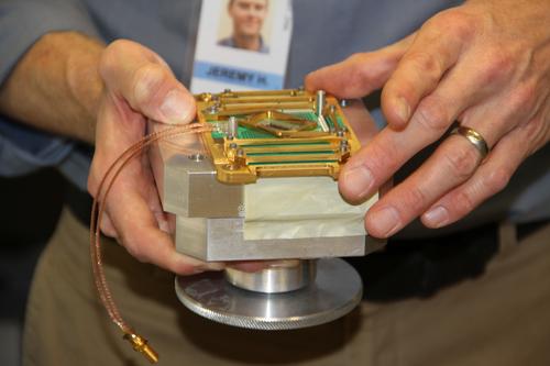 Jeremy Hilton, vice president of processor development of D-Wave, holding the 'Vesuvius' 512-qubit module that will be supercooled down to .2 milliKelvin using a 10kWatt refrigerator.
(Source: D-Wave)