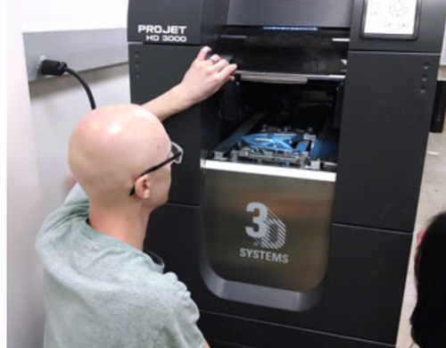 Berkeley Sensor and Actuator Center removing a prototype from the 3-D printer used to create the what are claimed to be the world's first working electronic components to be 3-D printed.
(Source: University of California Berkeley)