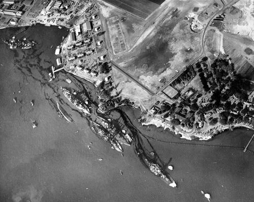 An aerial view of 'Battleship Row' moorings at Pearl Harbor, which shows damage from the Japanese raid conducted three days earlier. (Source: Wikipedia) 