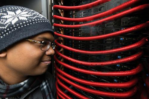 IBM engineer Milnes David inspects the chilled innards of a radiator-equipped IBM computer. IBM (Internet Evolution's sponsor) demonstrated the radiator technology in June 2012, when it built the world's fastest, hot-water cooled supercomputer for the Leibniz Superconductor Center in Germany.(Source: Jon Simon/Feature Photo Service for IBM) 