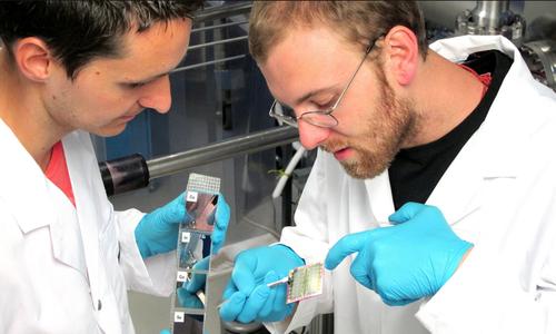 Empa doctoral candidates Patrick Reinhard and Benjamin Bessig check out the latest run of thin-film solar cells aiming for 25 percent efficiency.(Source: Eidgenossische Materialprufungs- und Forschungsanstalt (Empa)) 